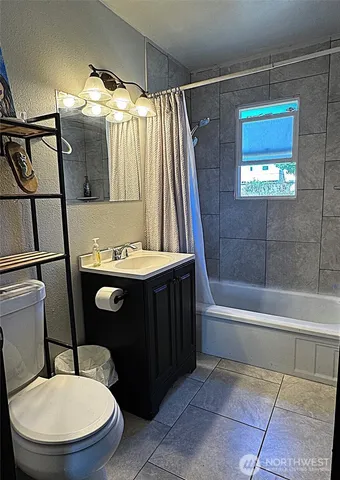a bathroom with a toilet a sink and bathtub