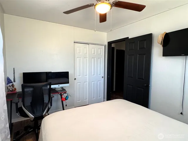 a bedroom with a bed and a flat tv screen