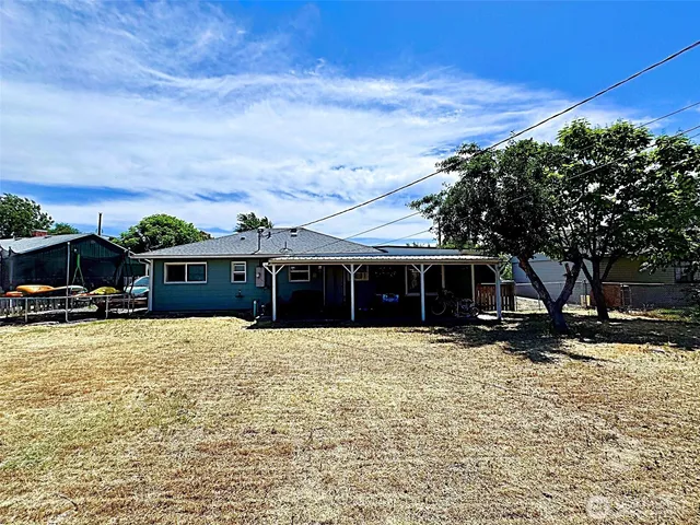 a front view of house with yard and car parked