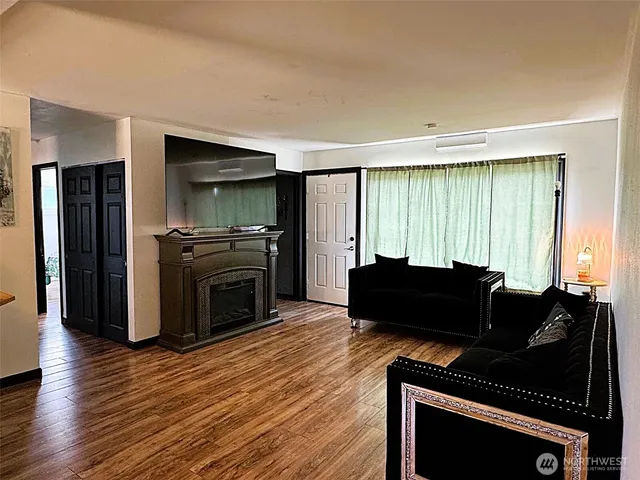 a living room with furniture windows and a fireplace