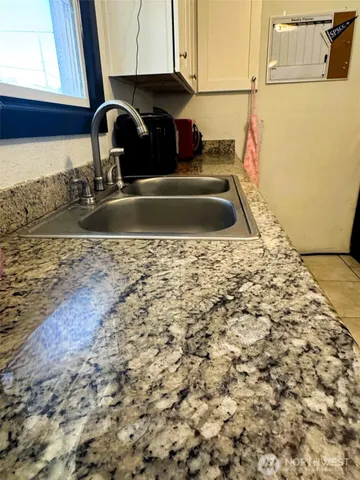 a kitchen with a sink and cabinets