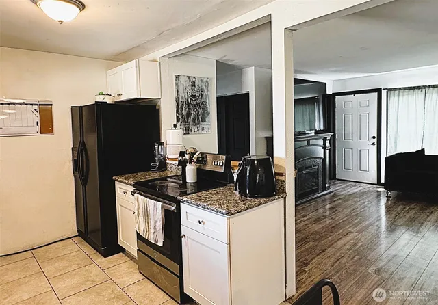 a kitchen with stainless steel appliances granite countertop a refrigerator and a stove
