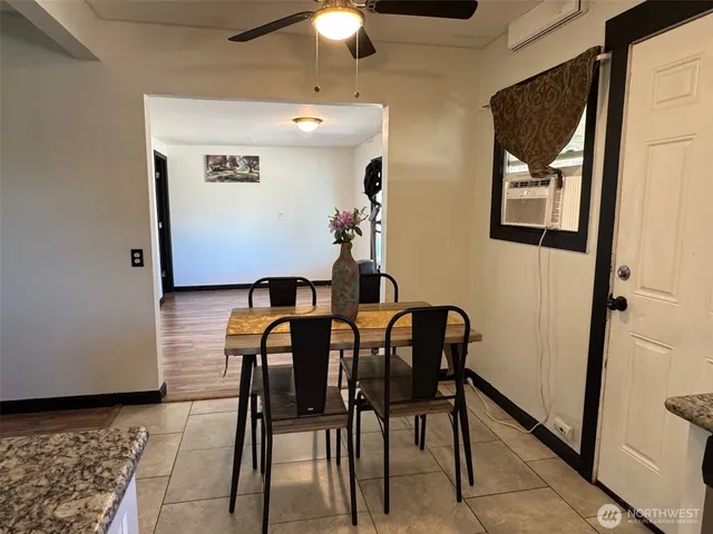 a view of a dining room with furniture and chandelier