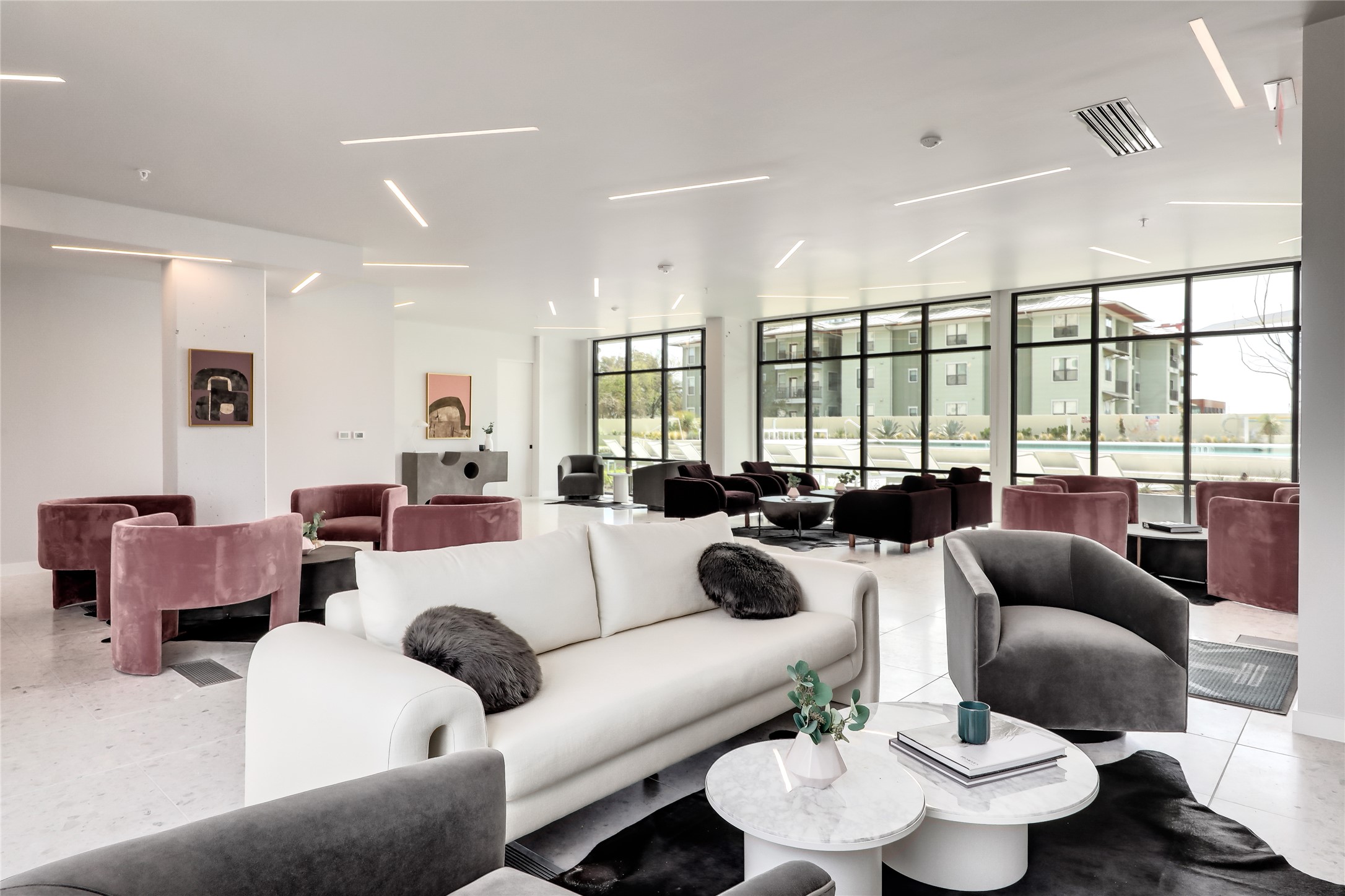 800 Embassy Drive, Unit 602 Austin, TX 78702 - Photo 29 of 37 Spacious lounge area featuring floor-to-ceiling windows, white terrazzo flooring, and linear recessed lighting