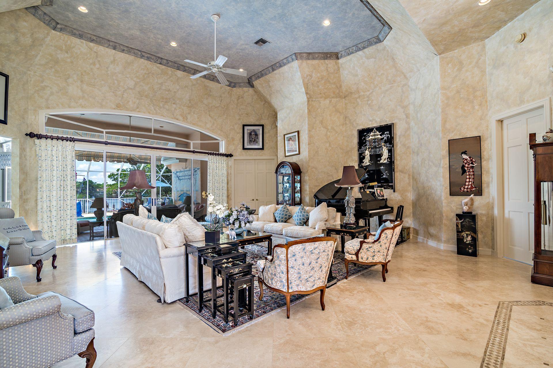 16757 Port Royal Circle Jupiter, FL 33477 - Photo 12 of 65 a living room with furniture and a large window