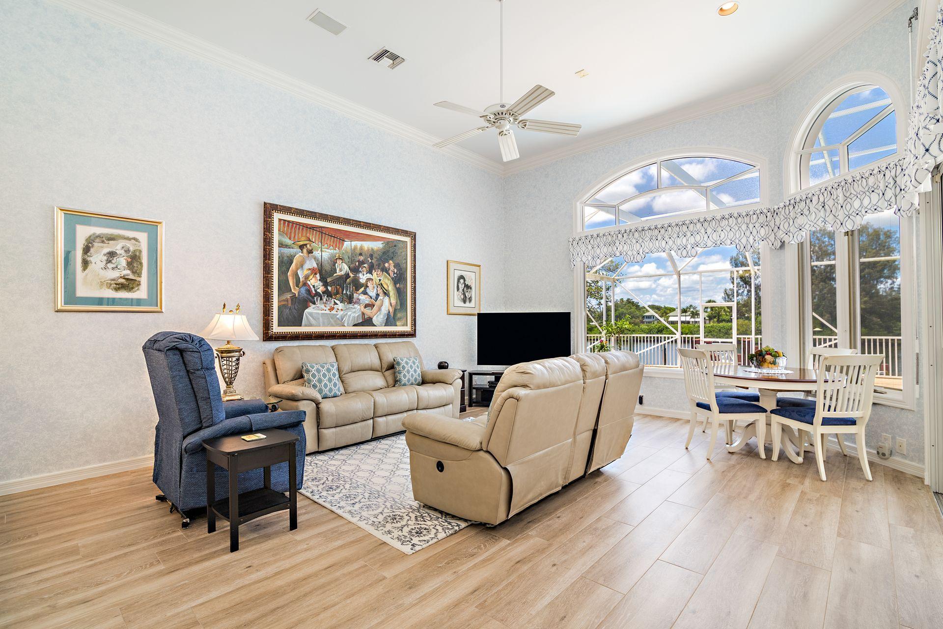 16757 Port Royal Circle Jupiter, FL 33477 - Photo 14 of 65 a living room with furniture and a large window