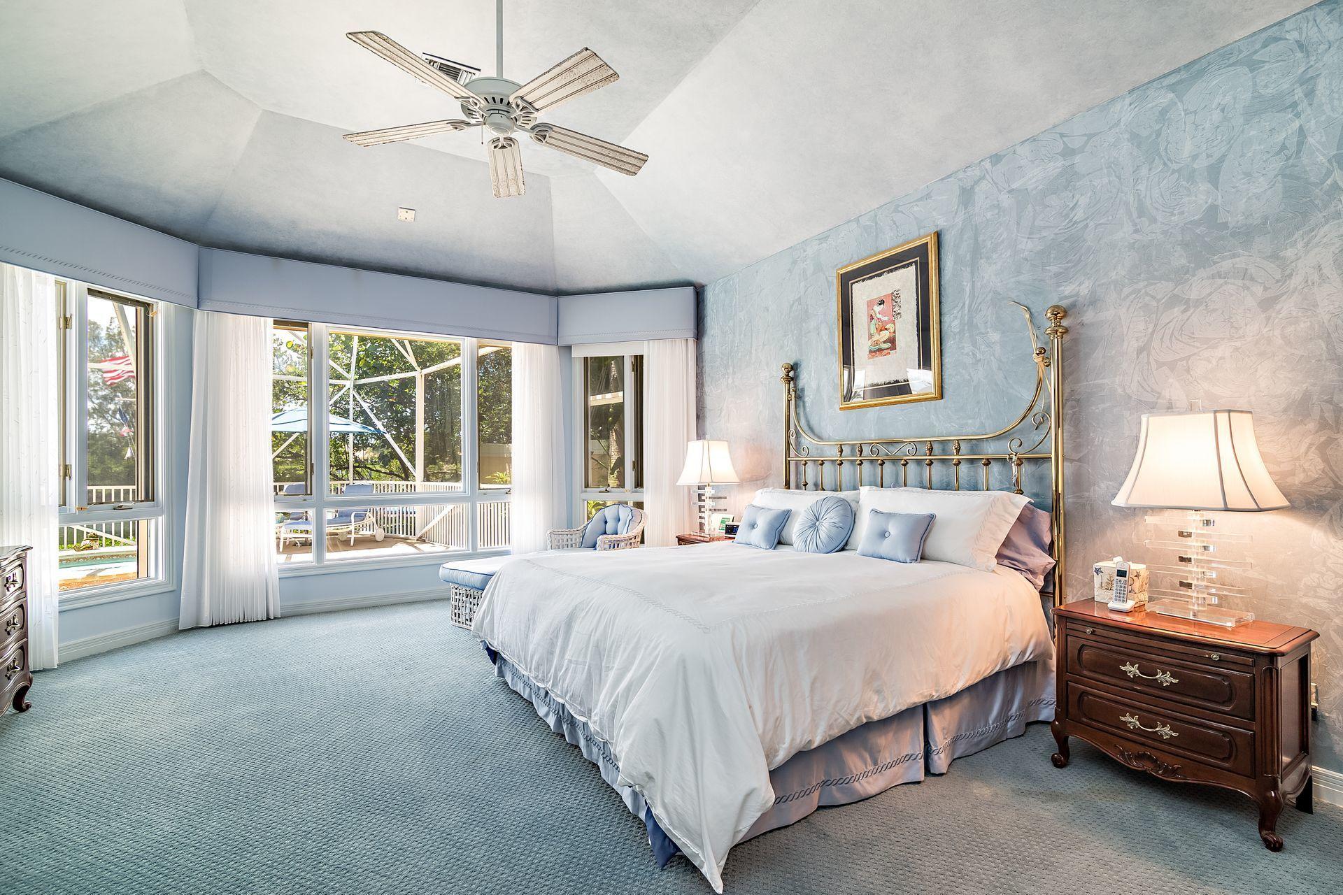 16757 Port Royal Circle Jupiter, FL 33477 - Photo 23 of 65 a bedroom with a bed and a large window