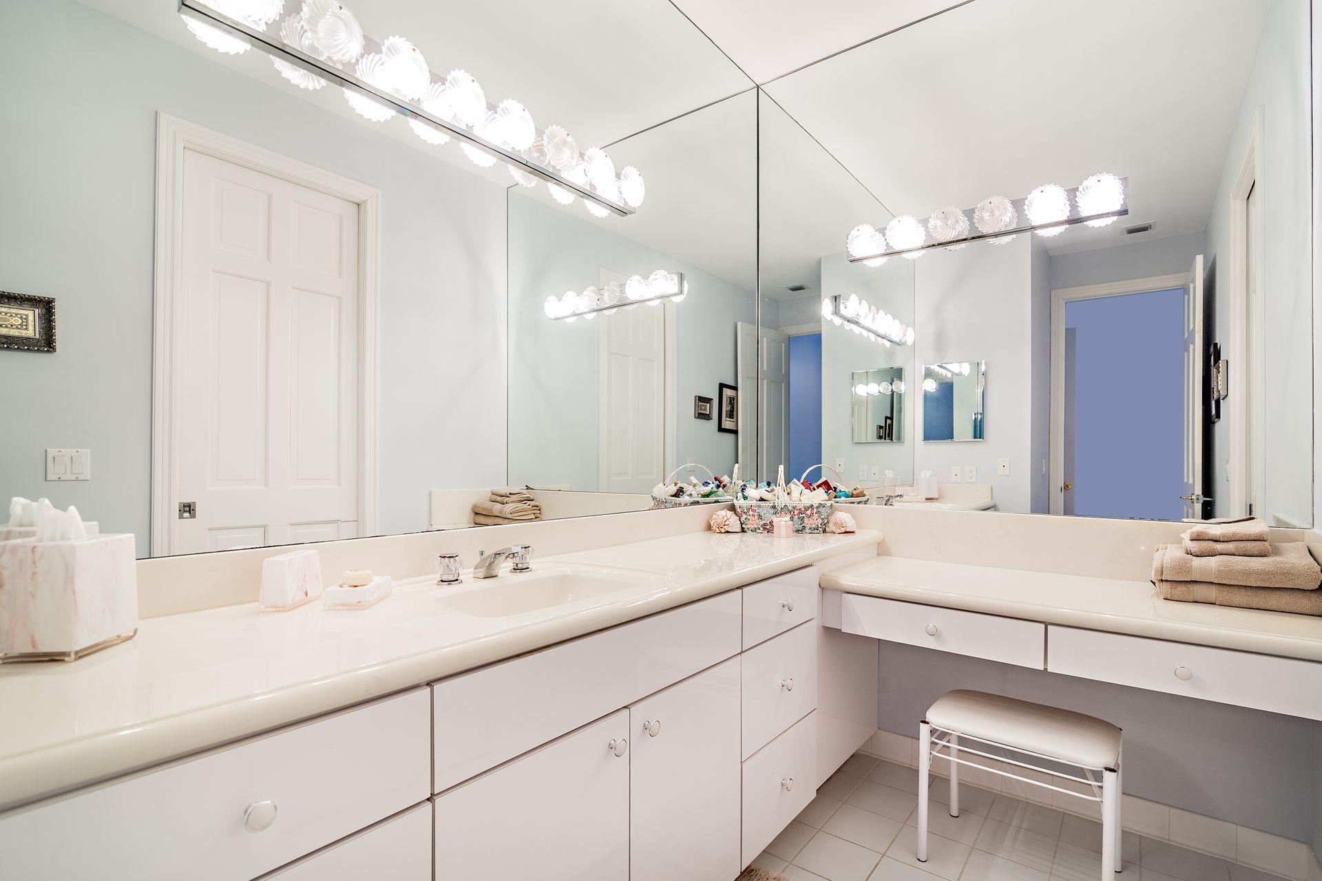 16757 Port Royal Circle Jupiter, FL 33477 - Photo 28 of 65 a bathroom with a sink double vanity and a mirror