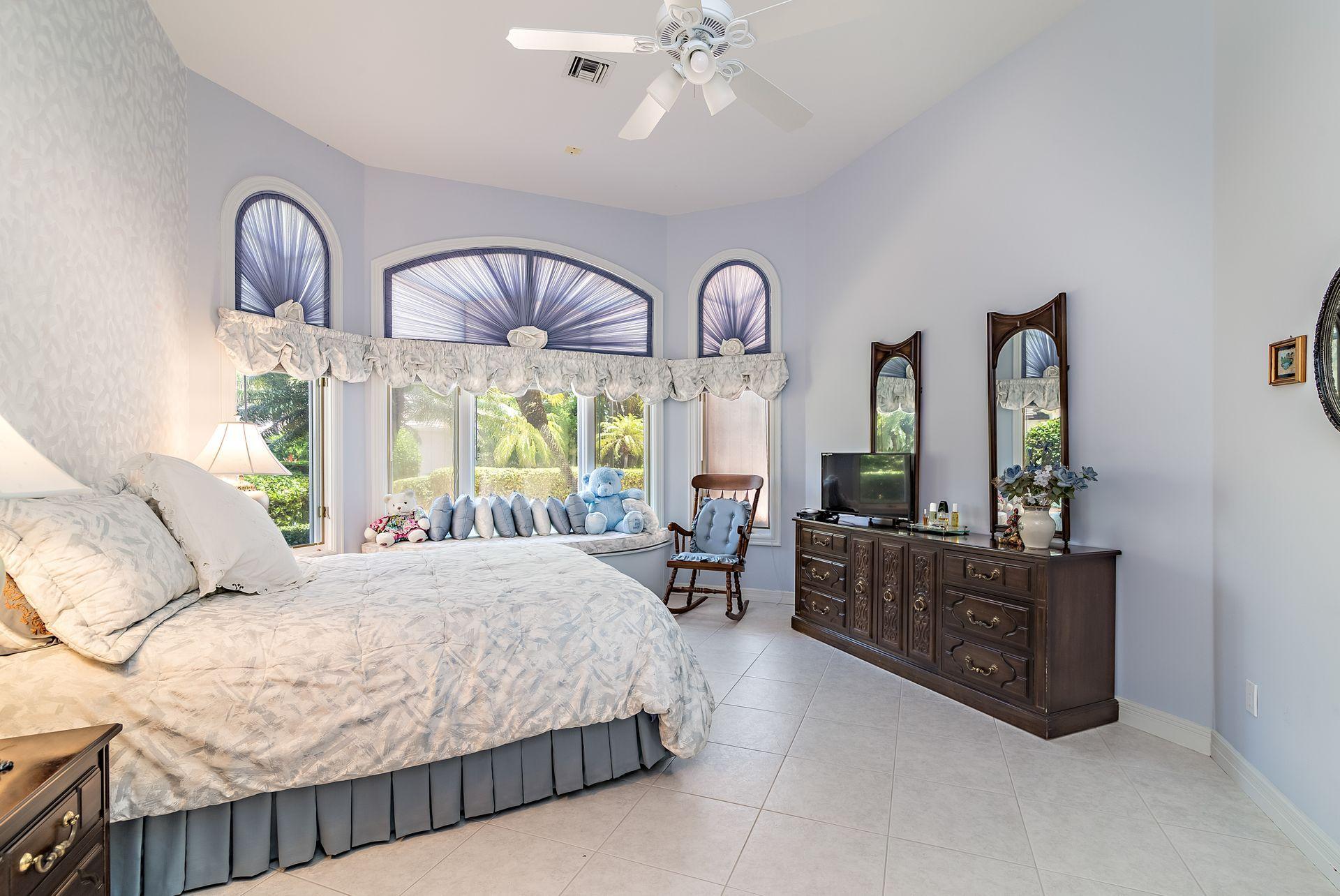 16757 Port Royal Circle Jupiter, FL 33477 - Photo 29 of 65 a bed room with a bed mirror and a window