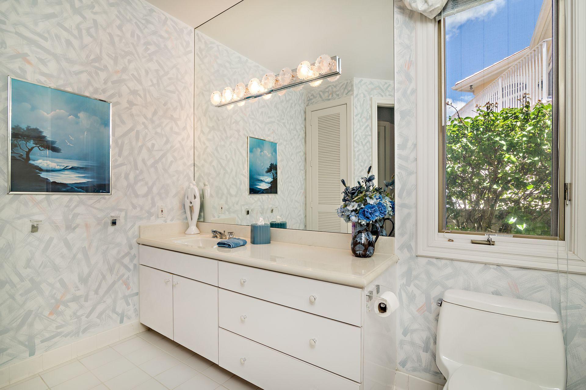 16757 Port Royal Circle Jupiter, FL 33477 - Photo 30 of 65 a bathroom with a double vanity sink mirror and shower