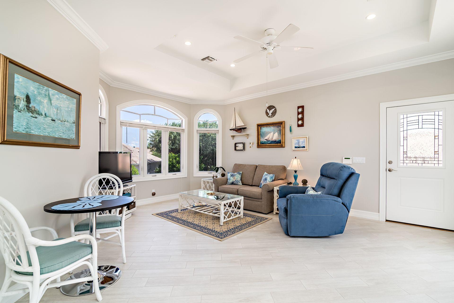 16757 Port Royal Circle Jupiter, FL 33477 - Photo 39 of 65 a living room with furniture and a potted plant