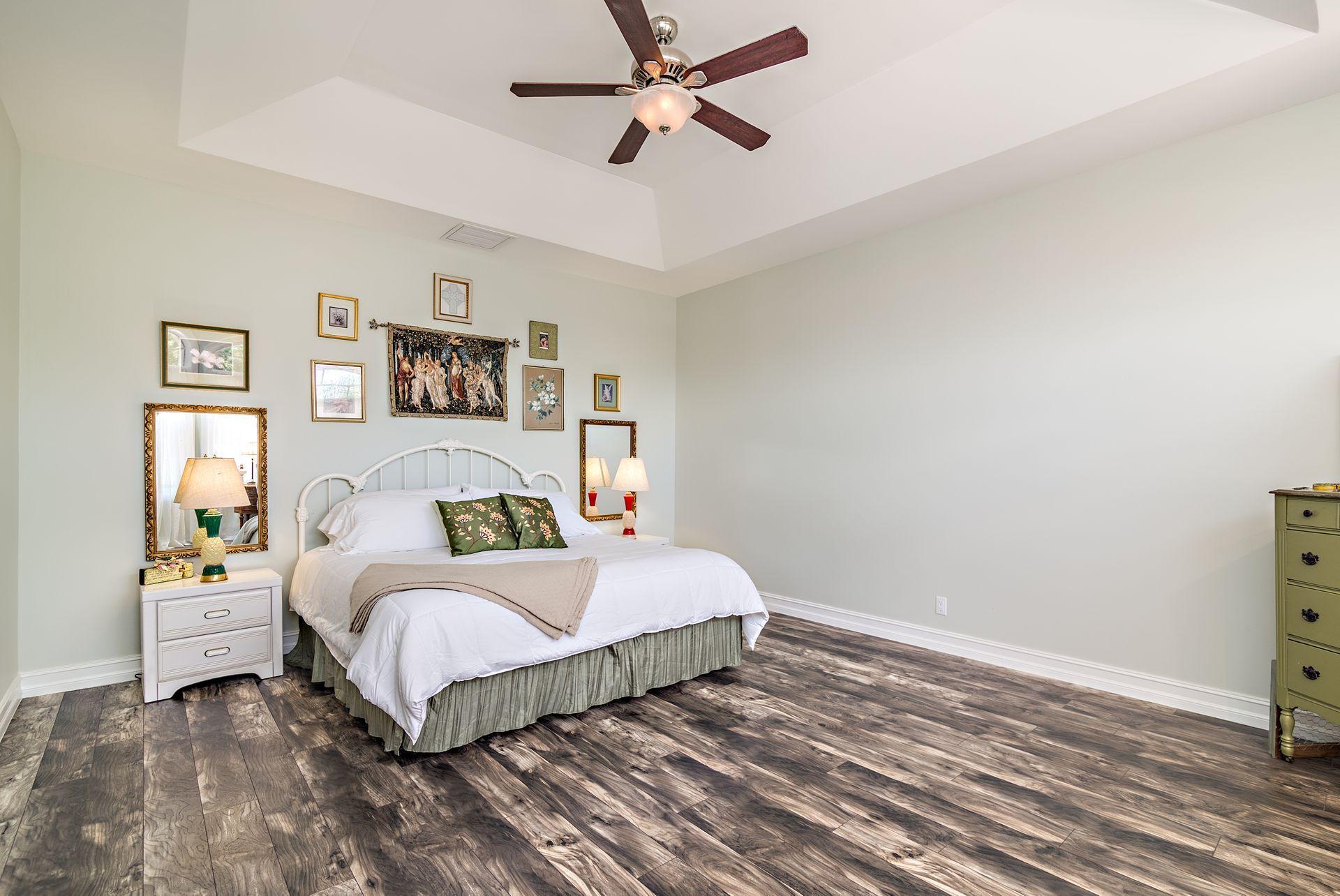 16757 Port Royal Circle Jupiter, FL 33477 - Photo 40 of 65 a bedroom with a bed and painting on the wall