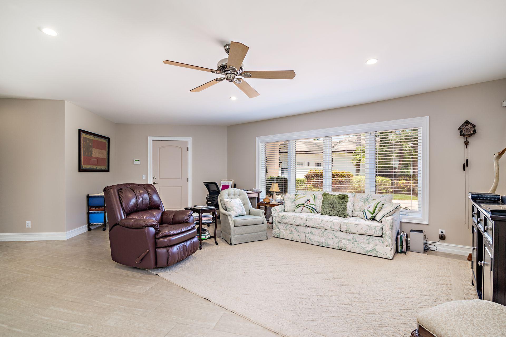 16757 Port Royal Circle Jupiter, FL 33477 - Photo 42 of 65 a living room with furniture and a large window