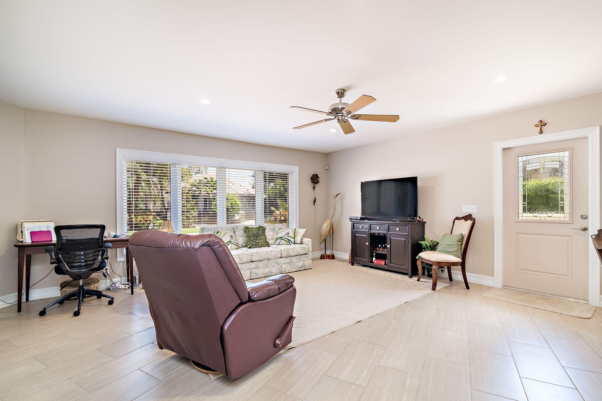 16757 Port Royal Circle Jupiter, FL 33477 - Photo 43 of 65 a living room with furniture fireplace and a window