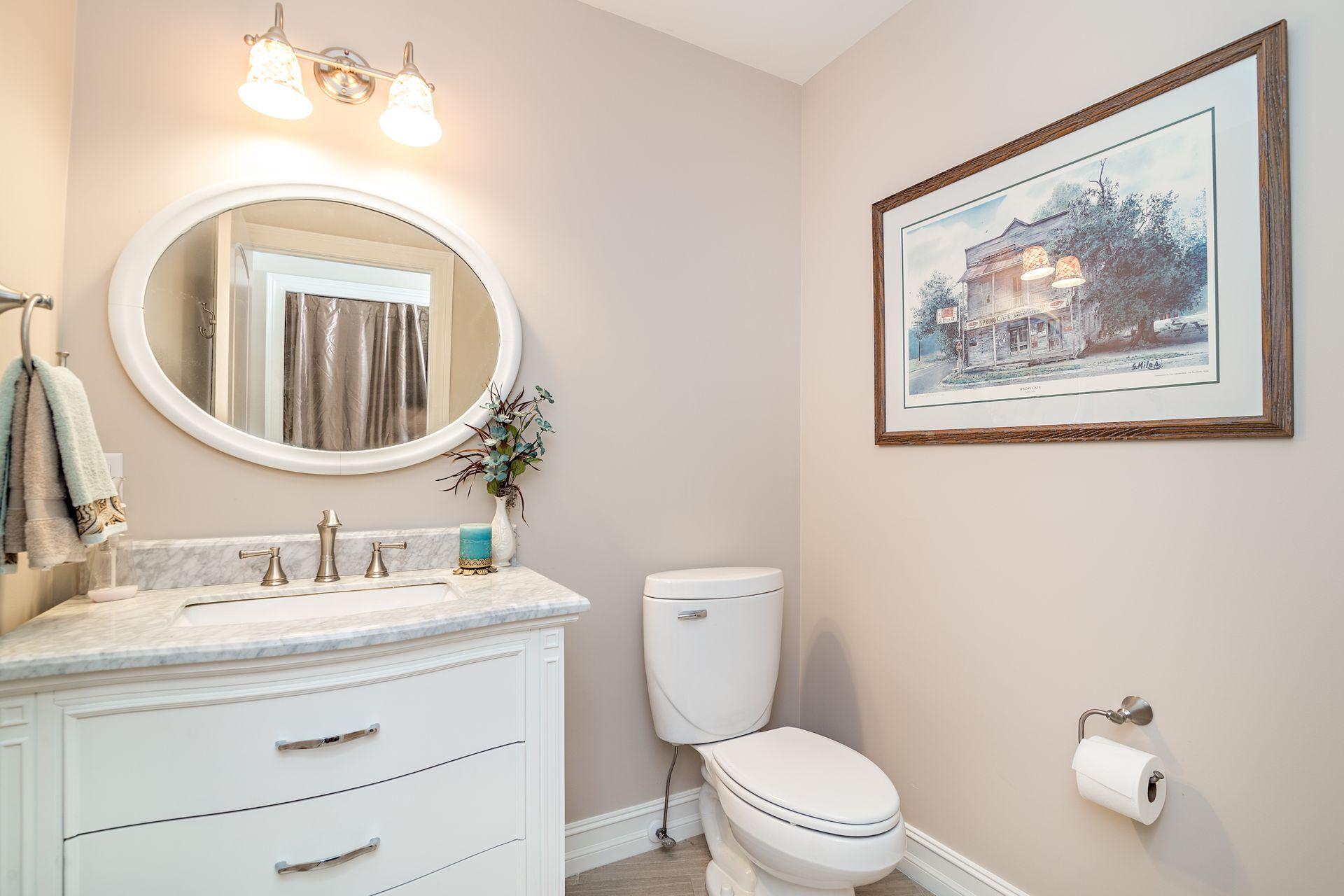 16757 Port Royal Circle Jupiter, FL 33477 - Photo 45 of 65 a bathroom with a toilet a sink and mirror