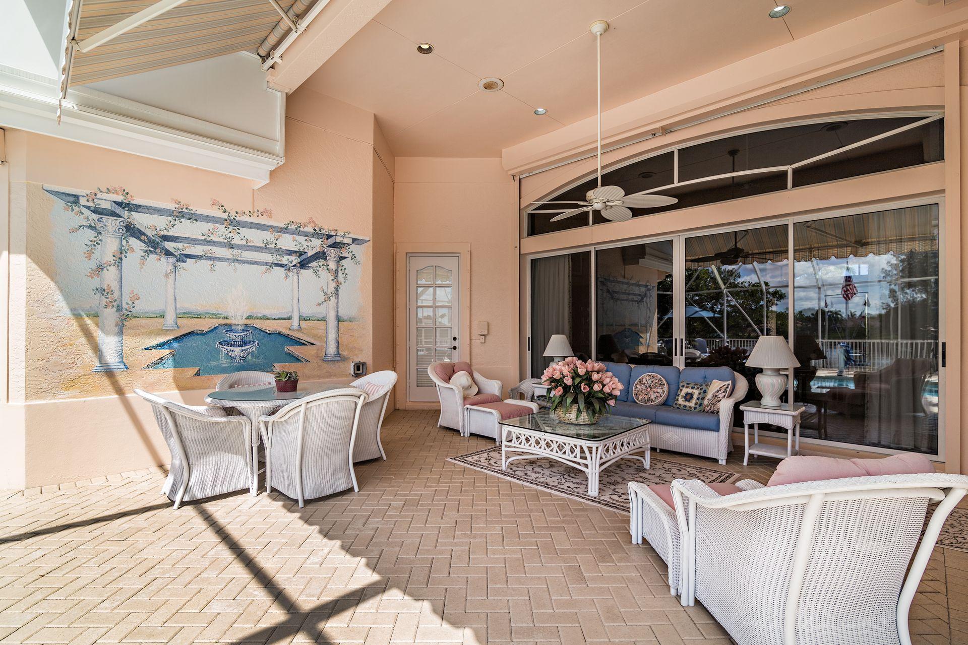 16757 Port Royal Circle Jupiter, FL 33477 - Photo 46 of 65 a living room with a couch and a table