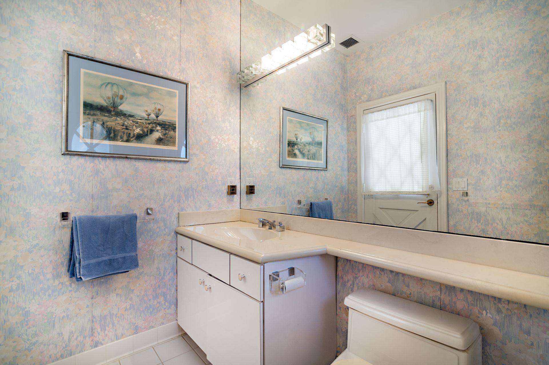 16757 Port Royal Circle Jupiter, FL 33477 - Photo 48 of 65 a bathroom with a sink and a mirror