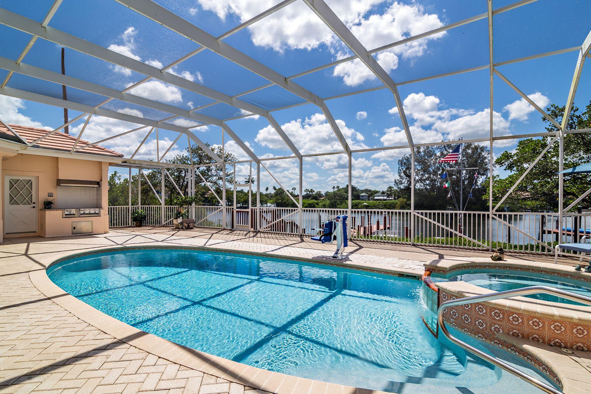 16757 Port Royal Circle Jupiter, FL 33477 - Photo 50 of 65 a view of a patio with swimming pool