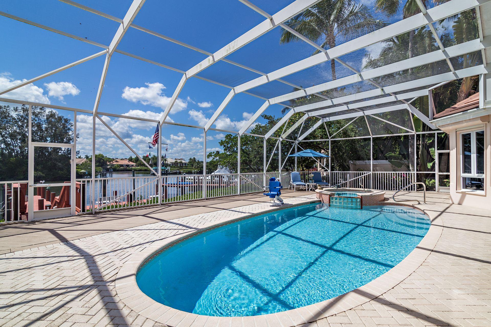 16757 Port Royal Circle Jupiter, FL 33477 - Photo 51 of 65 a view of a swimming pool with sitting area