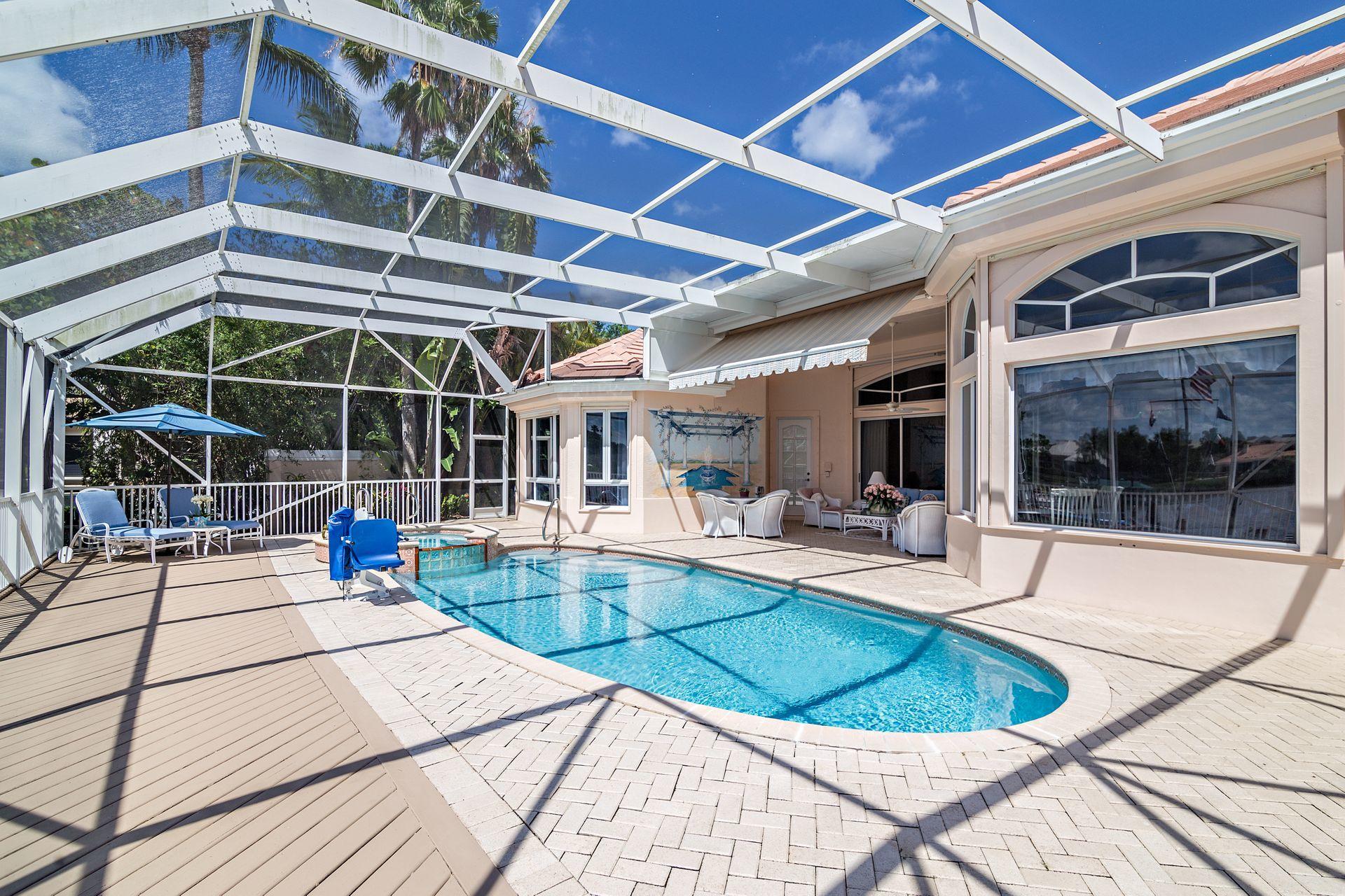 16757 Port Royal Circle Jupiter, FL 33477 - Photo 52 of 65 a view of a swimming pool with a patio