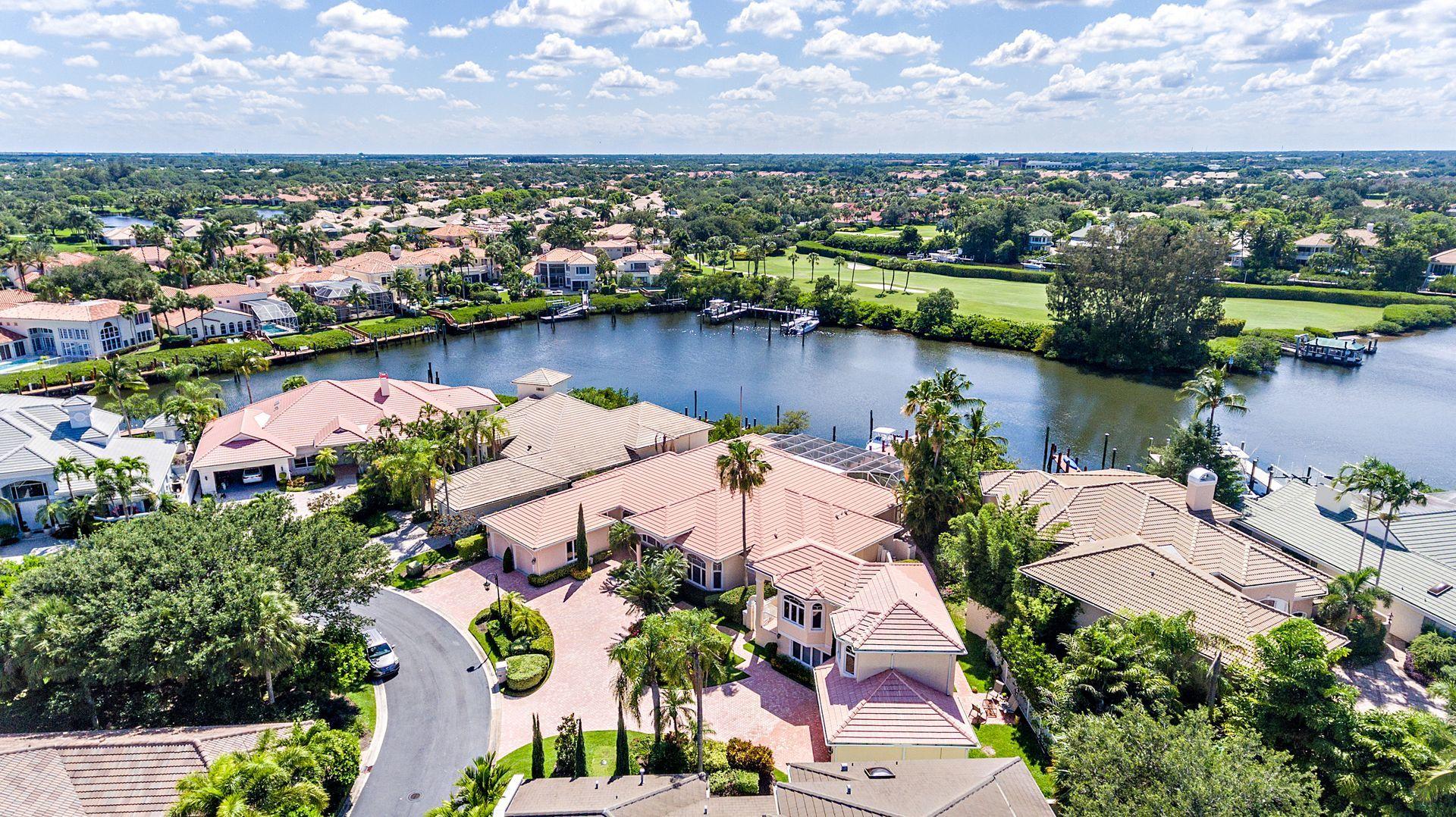 16757 Port Royal Circle Jupiter, FL 33477 - Photo 60 of 65 an aerial view of lake and residential houses with outdoor space and lake view