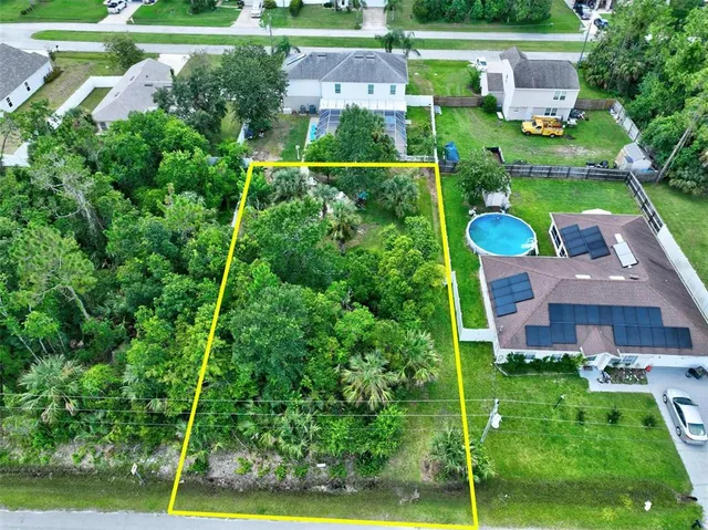 a view of a table and chairs in patio with a yard