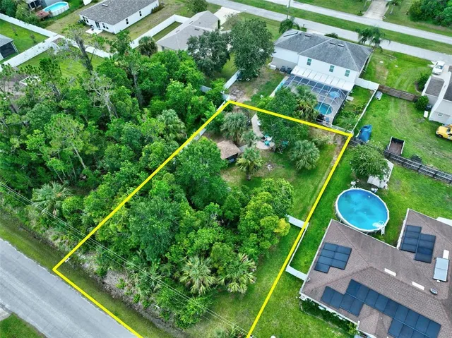 a backyard of a house with lots of green space and plants