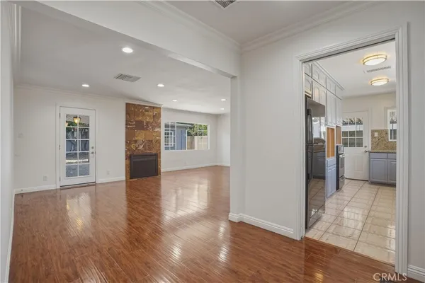 a view of a kitchen with wooden floor and a kitchen
