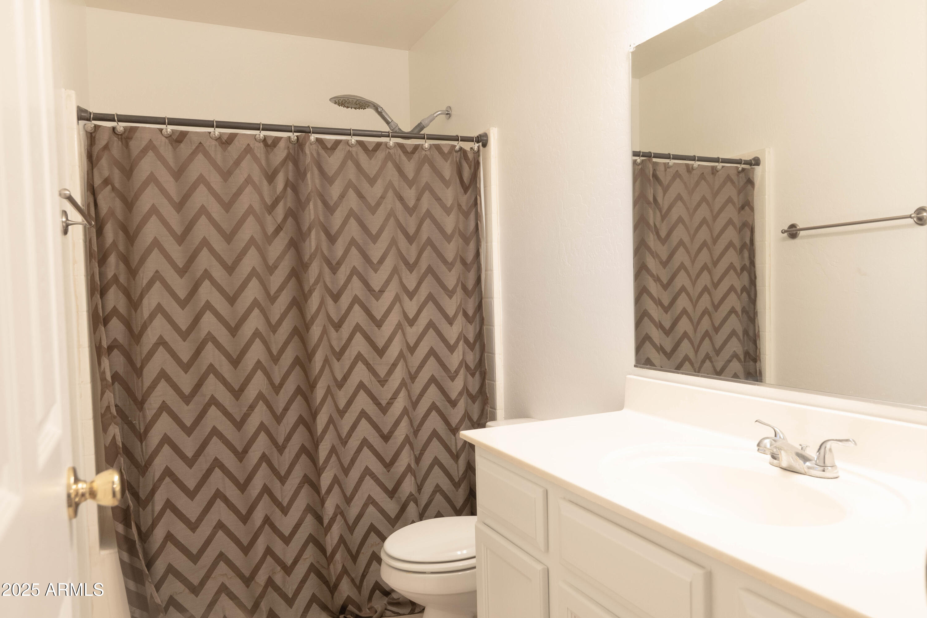 10649 West Monte Vista Road Avondale, AZ 85392 - Photo 18 of 28 a bathroom with a sink and a mirror
