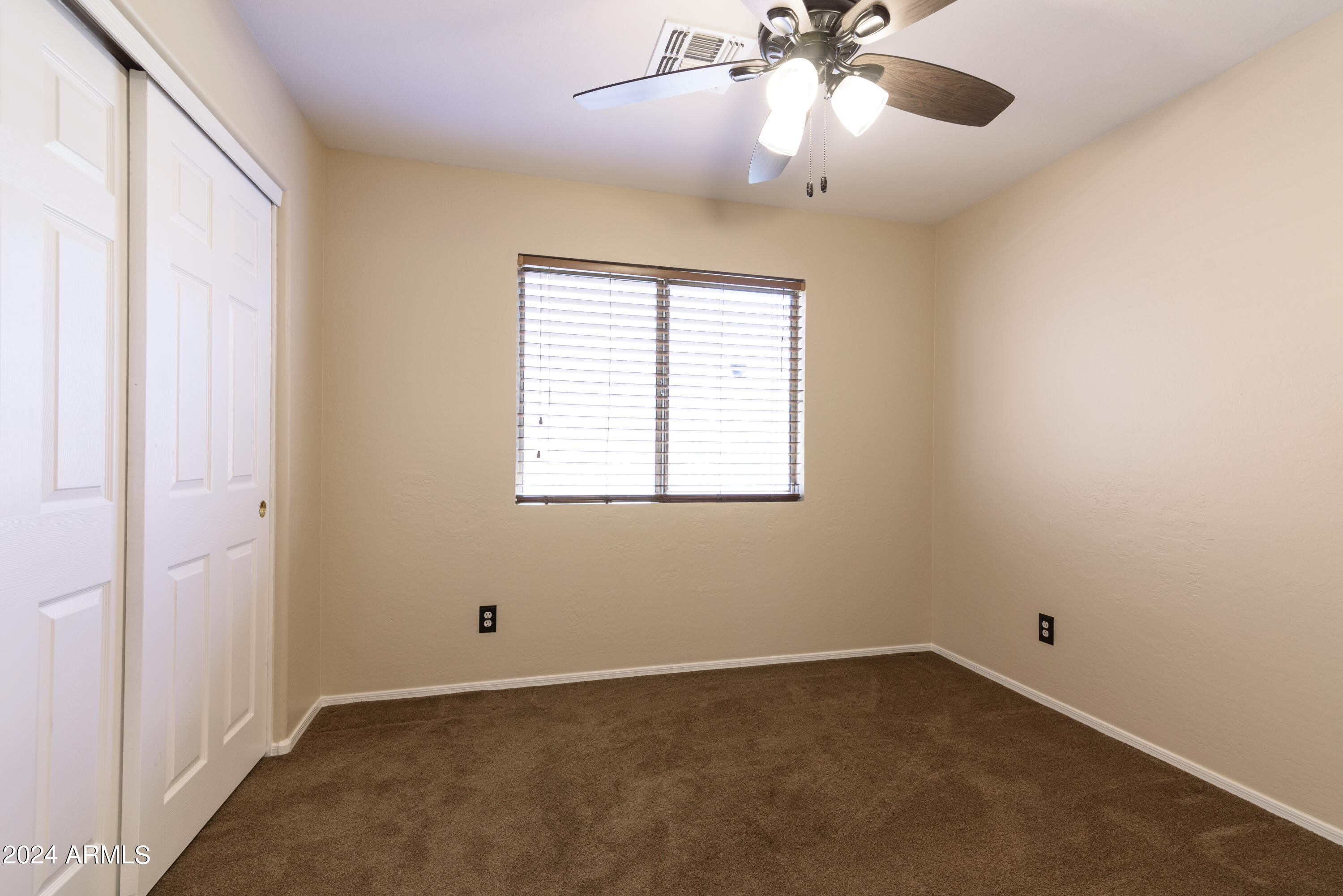 10649 West Monte Vista Road Avondale, AZ 85392 - Photo 19 of 28 a view of an empty room with a window