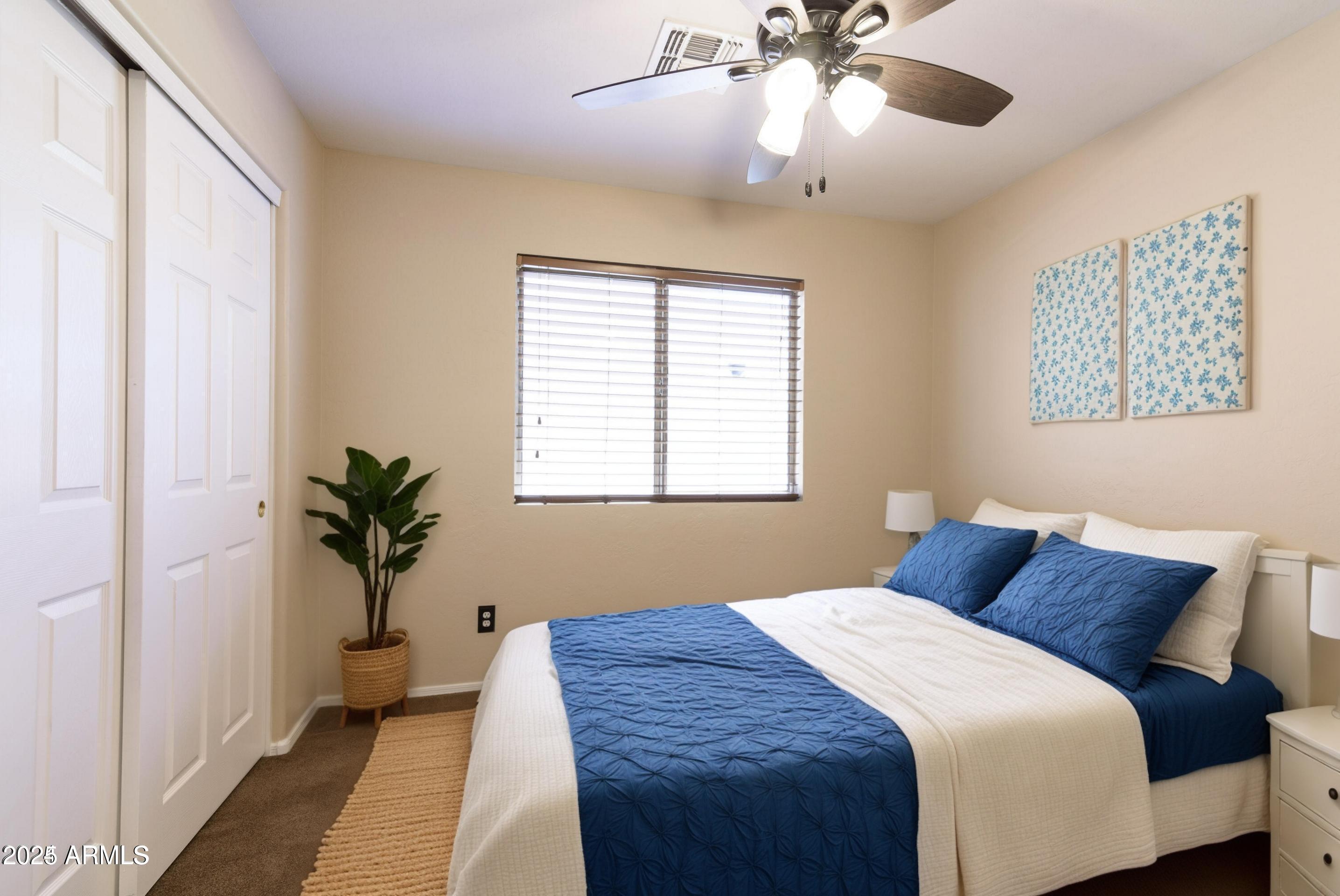 10649 West Monte Vista Road Avondale, AZ 85392 - Photo 20 of 28 a bedroom with a large bed and a window