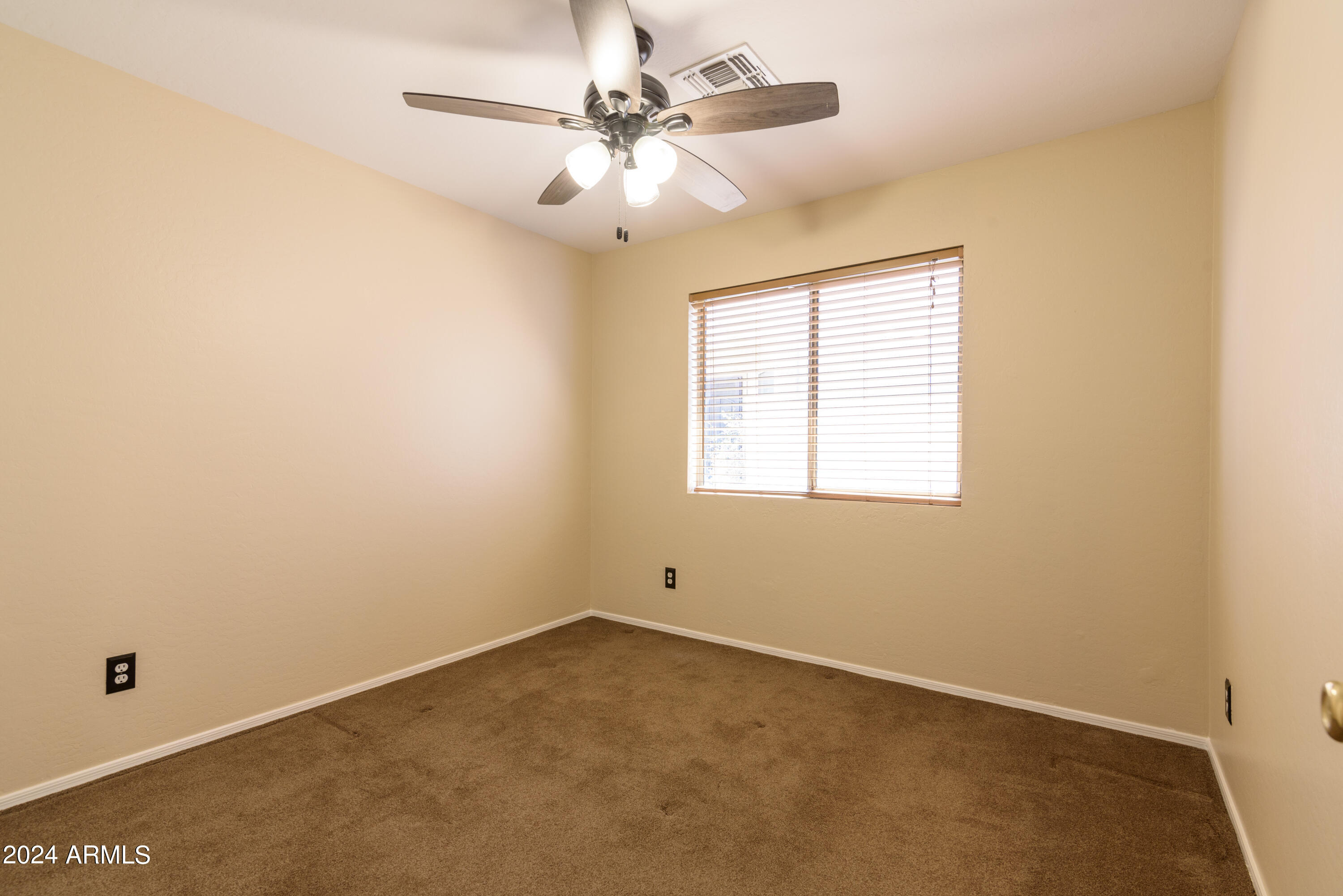 10649 West Monte Vista Road Avondale, AZ 85392 - Photo 21 of 28 an empty room with a window