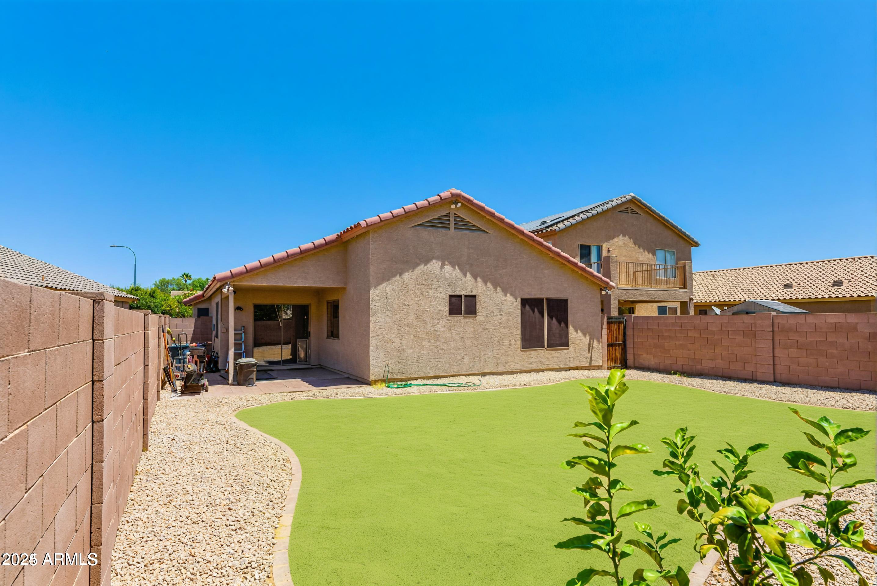 10649 West Monte Vista Road Avondale, AZ 85392 - Photo 26 of 28 a front view of house with yard and seating area
