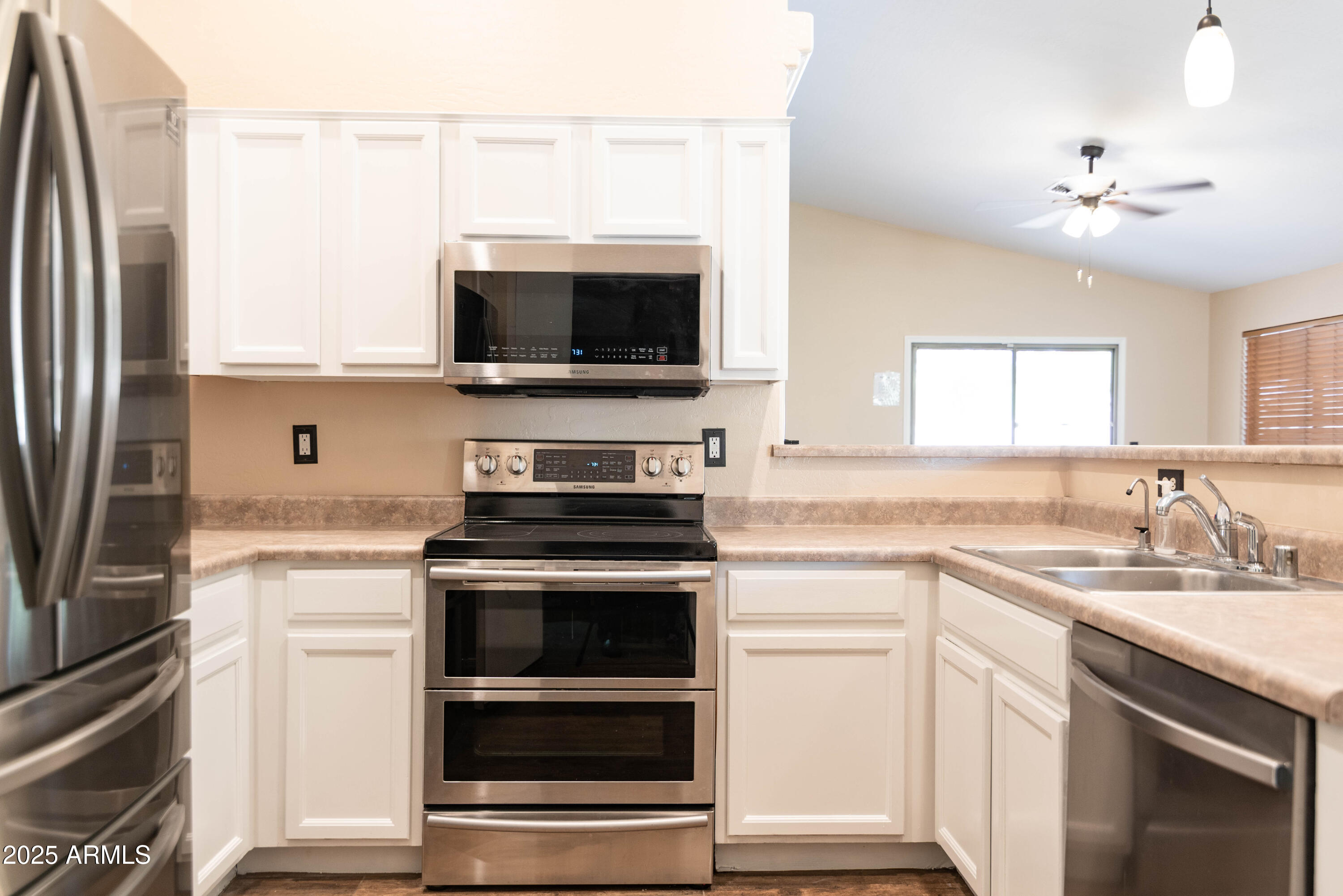 10649 West Monte Vista Road Avondale, AZ 85392 - Photo 4 of 28 a kitchen with a stove and a microwave