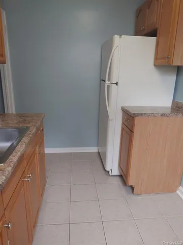 a view of a kitchen with refrigerator and microwave