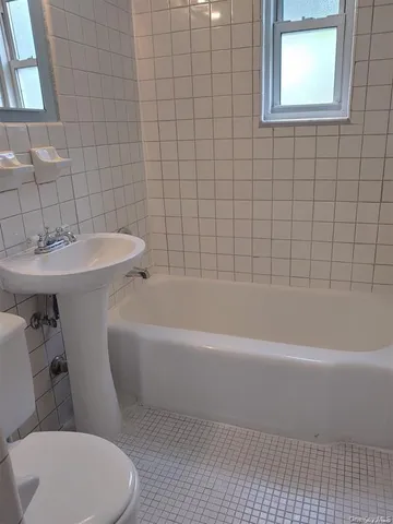 a bathroom with a sink a toilet and bathtub