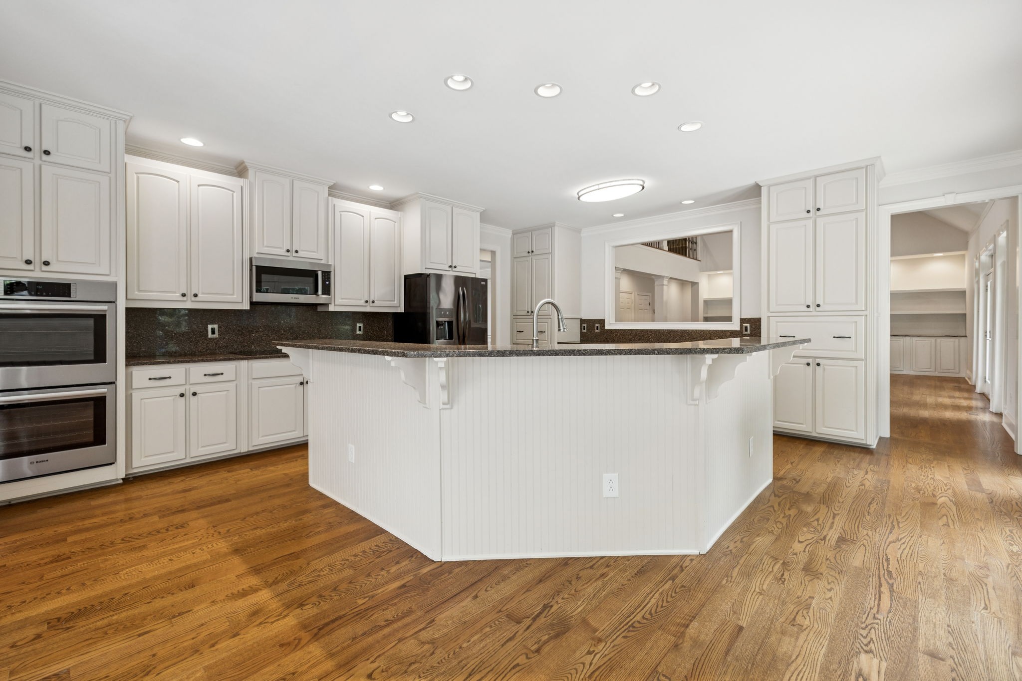 1416 Swindell Hollow Road Lebanon, TN 37090 - Photo 13 of 81 a kitchen with stainless steel appliances kitchen island granite countertop a stove a sink and white cabinets