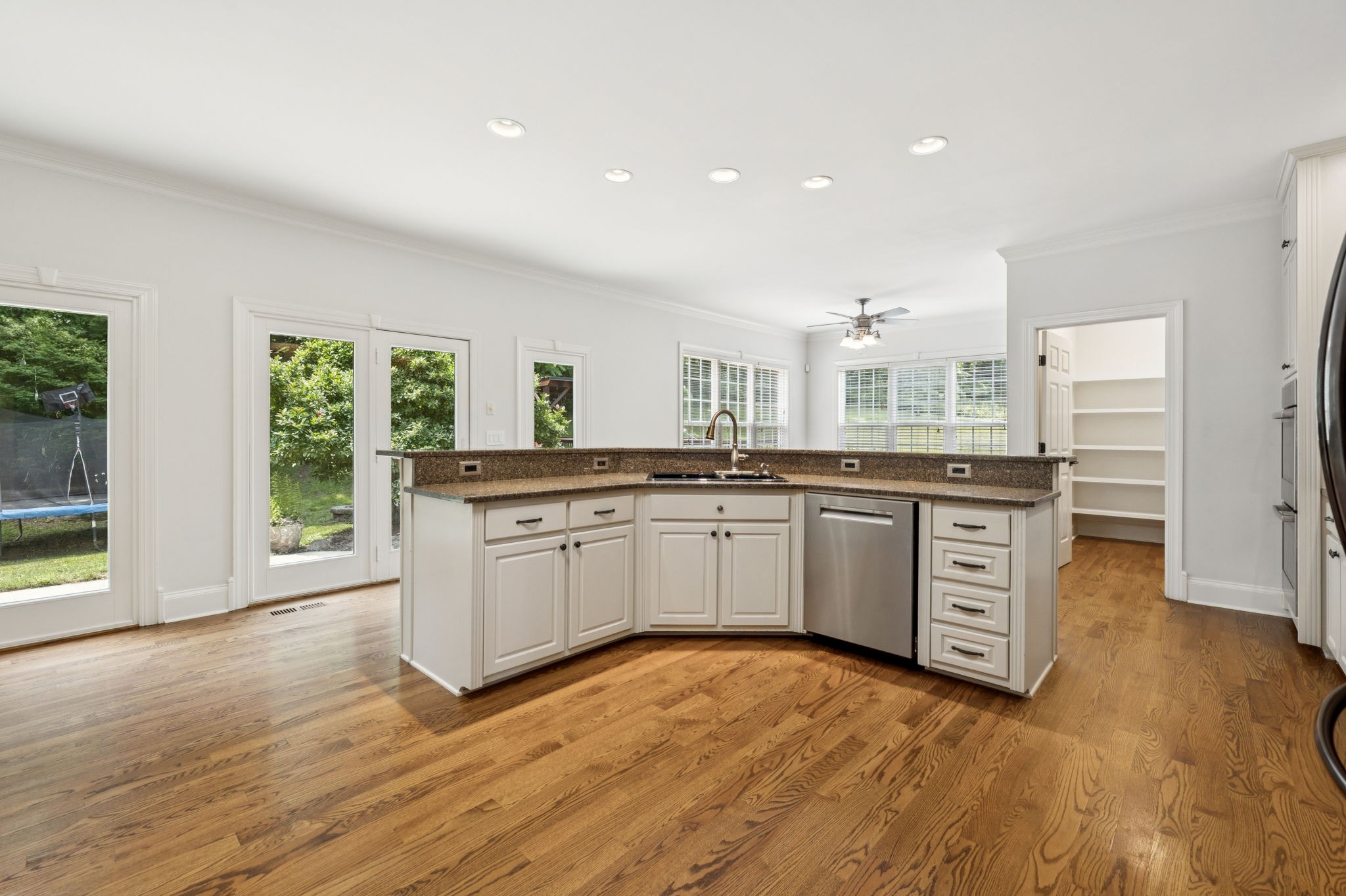 1416 Swindell Hollow Road Lebanon, TN 37090 - Photo 16 of 81 a kitchen with stainless steel appliances granite countertop a stove a sink and white cabinets with wooden floor