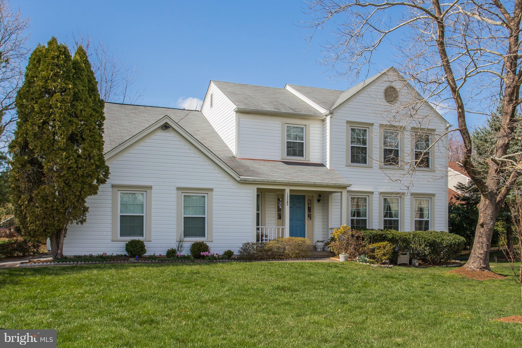 13345 Point Rider Lane Herndon, VA 20171 - Photo 2 of 30 a front view of a house with a yard