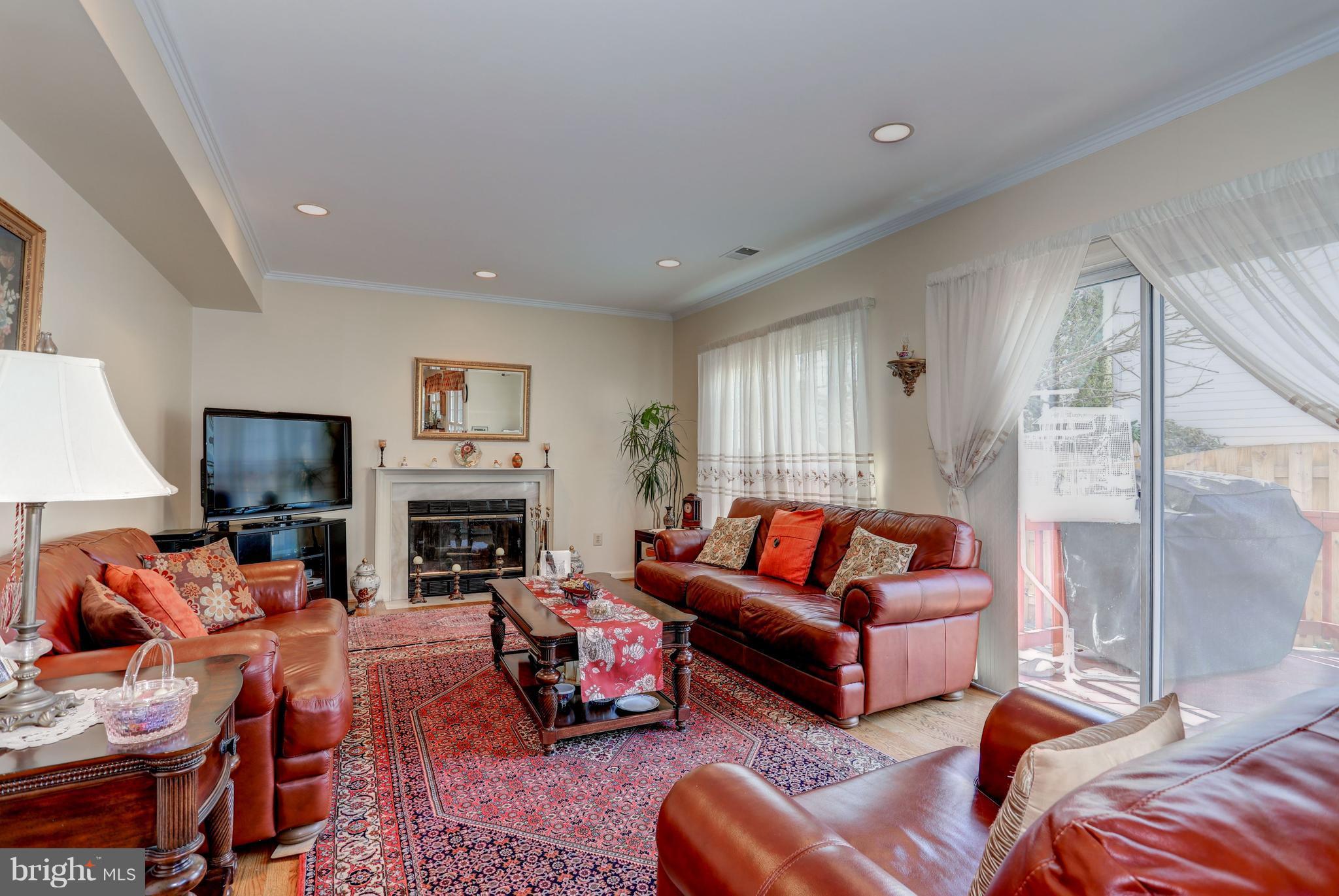 13345 Point Rider Lane Herndon, VA 20171 - Photo 14 of 30 a living room with furniture a fireplace and a flat screen tv