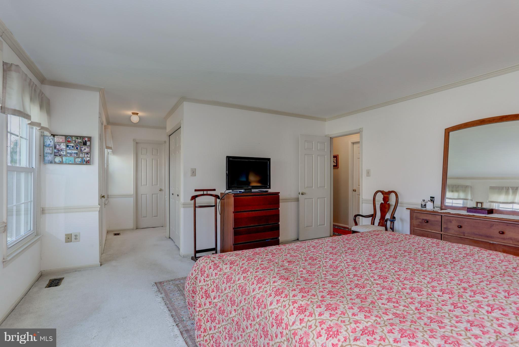 13345 Point Rider Lane Herndon, VA 20171 - Photo 17 of 30 a bedroom with a bed and a flat screen tv