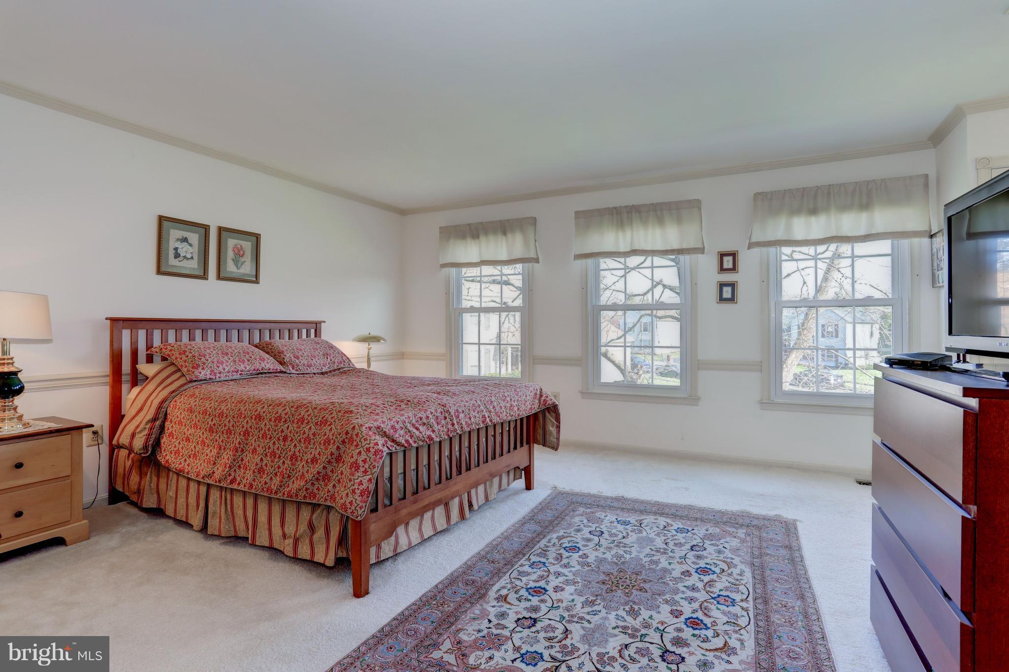 13345 Point Rider Lane Herndon, VA 20171 - Photo 19 of 30 a bedroom with a bed and a flat screen tv