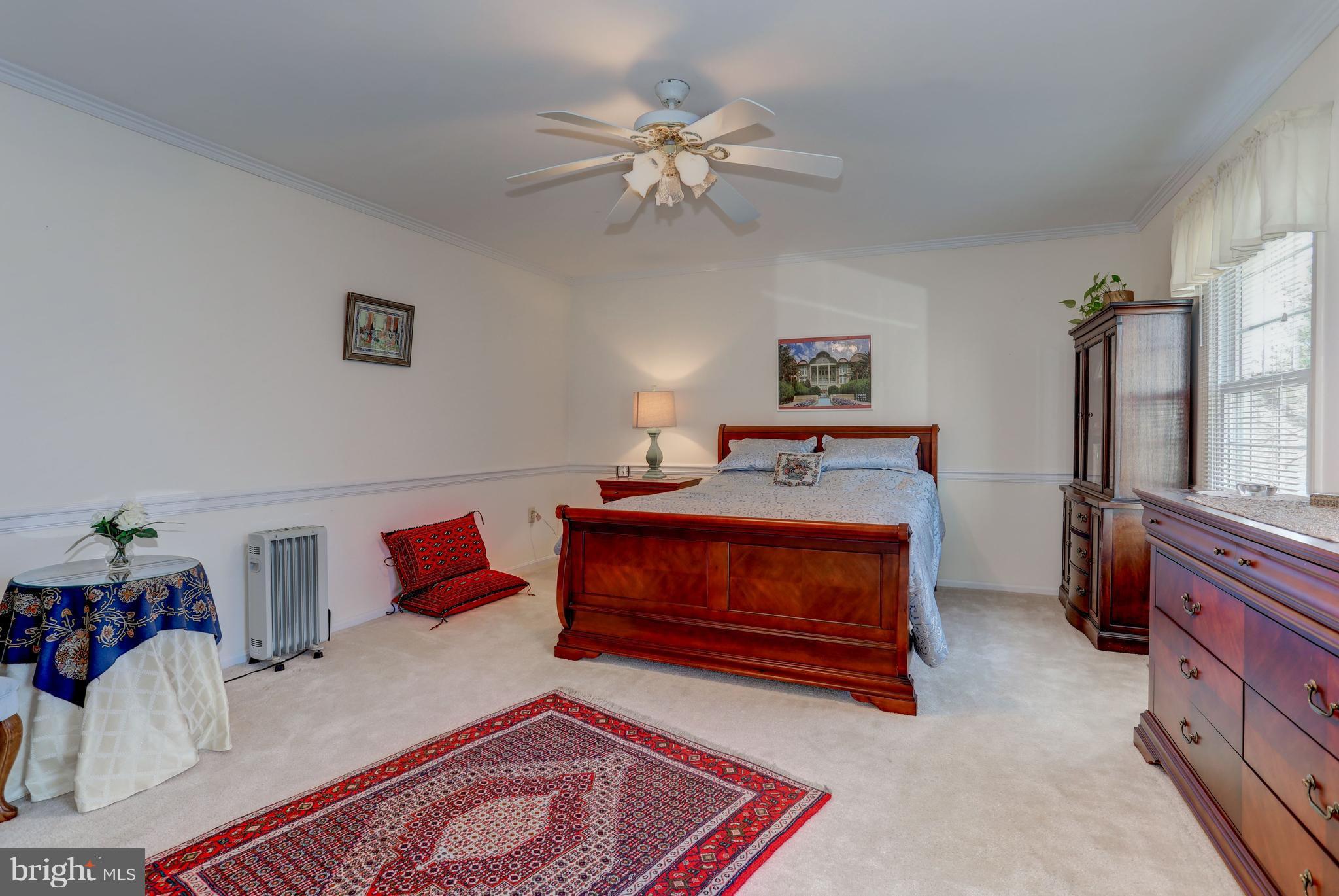 13345 Point Rider Lane Herndon, VA 20171 - Photo 22 of 30 a bedroom with furniture and a chandelier