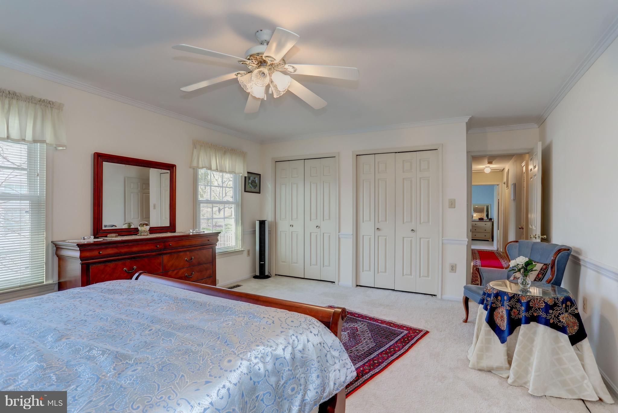 13345 Point Rider Lane Herndon, VA 20171 - Photo 23 of 30 a bedroom with a bed and a chandelier