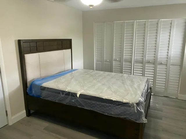 a bed sitting in a bedroom next to a window