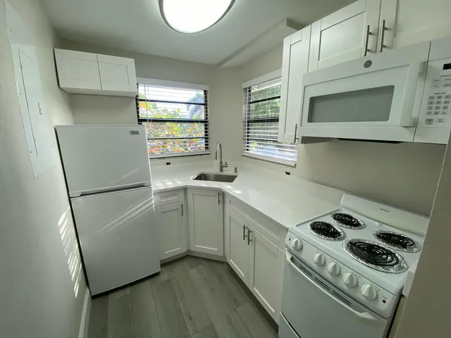 a kitchen with a refrigerator and a stove