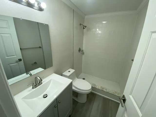 a bathroom with a sink toilet and shower