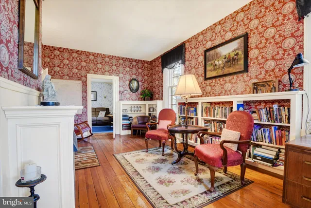 a living room with fireplace furniture and a book shelf