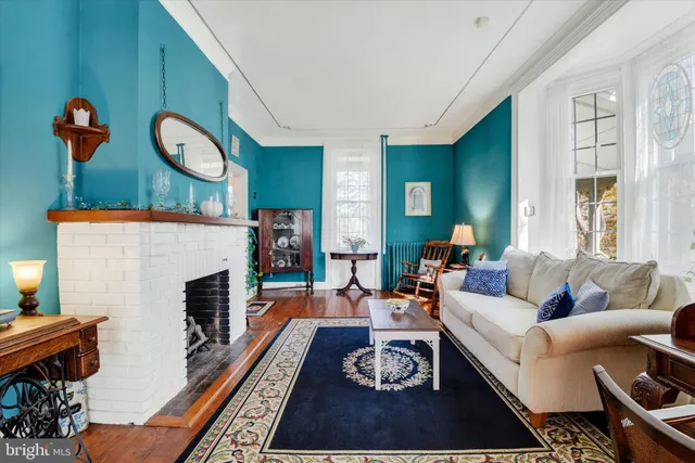 a living room with furniture a rug and a fireplace