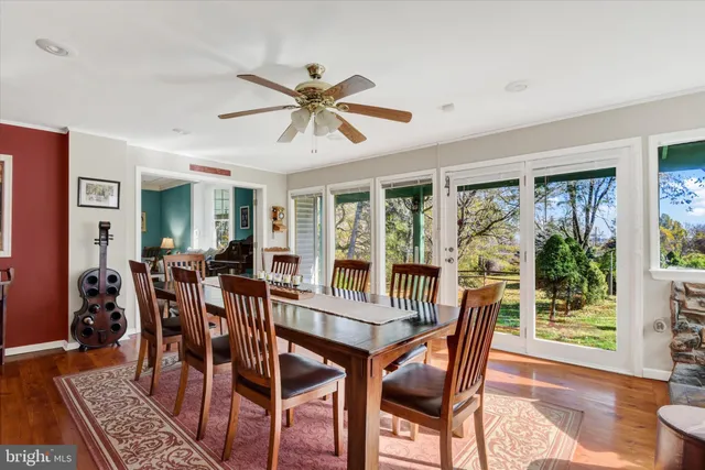 a dining room with furniture window and wooden floor